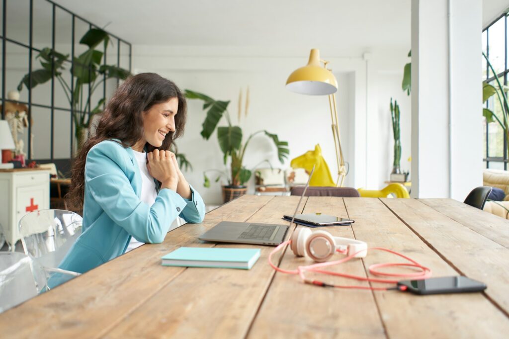 Young Latin American businesswoman in an online meeting using a laptop